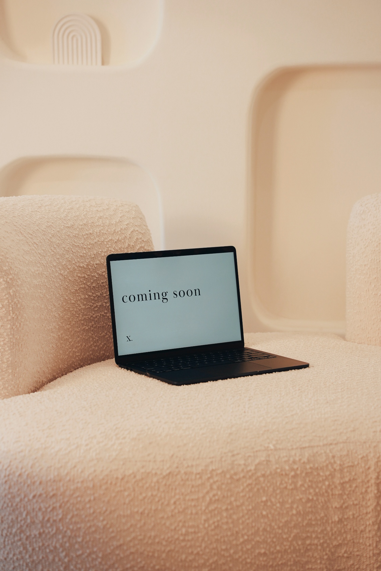 Luxe Co. campaign moment, laptop on bouclé chair